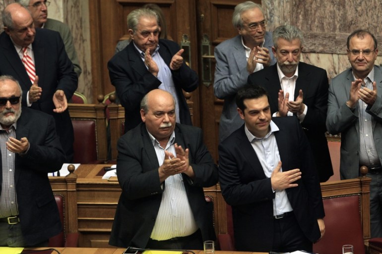 Tsipras is applauded by the members of the cabinet after his speech, during a debate on the referendum in the plenary session at the Greek Parliament in Athens [EPA]