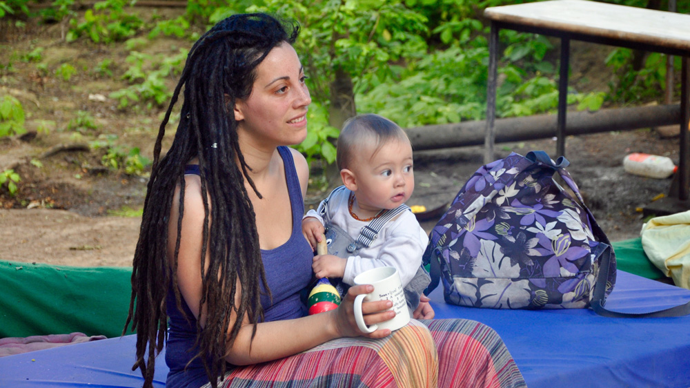 Maria Sanders, an Occupy Democracy activist, with her baby at the Runnymede Eco-Village [Simon Hooper/Al Jazeera]
