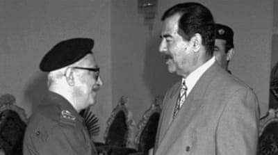 Tariq Aziz greets Saddam Hussein in Baghdad, Iraq in 1998 [AP]