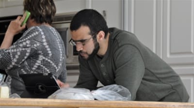 Omar Khadr looking at an iPad [Getty]