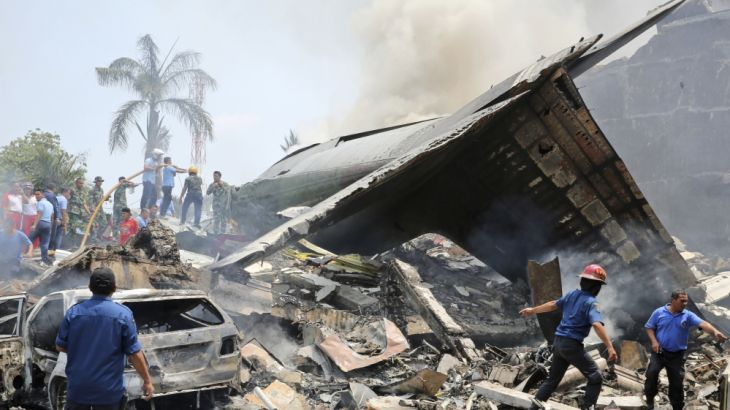 Indonesian military personnel search for victims at the site where an air force cargo plane crashed in Medan,