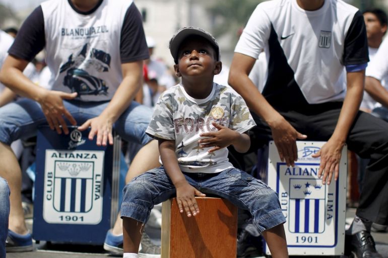 A boy plays his cajon, a popular Peruvian instrument, during the 8th International Festival of the Peruvian Cajon in Lima''s Plaza Mayor