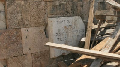 This plaque in Hebrew previously marked the entrance to the cemetery [Venetia Rainey/Al Jazeera]