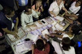 Poll workers count ballots underneath a street lights, at an outdoor poling station in Chilpancingo, Guerrero State, Mexico [AP]