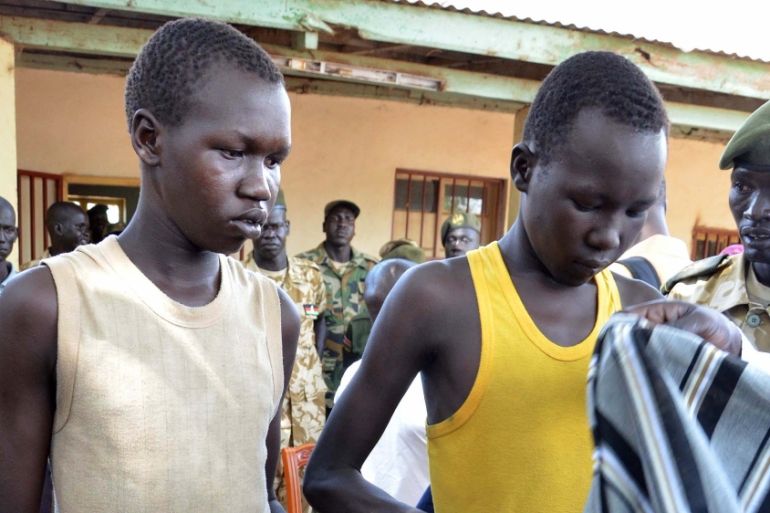 Two child soldiers leave their uniforms during a ceremony of disarmament in Juba, South Sudan [Getty]