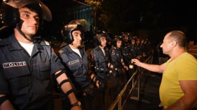 Policemen stand during a protest against an increase in electricity prices in Yerevan [Getty]