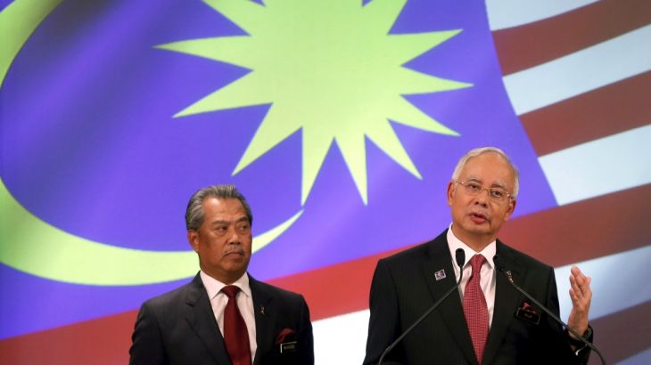 File photo of Malaysia''s PM Najib speaks as his deputy Muhyiddin listens during announcement of the new cabinet ministers lineup at his office in Putrajaya