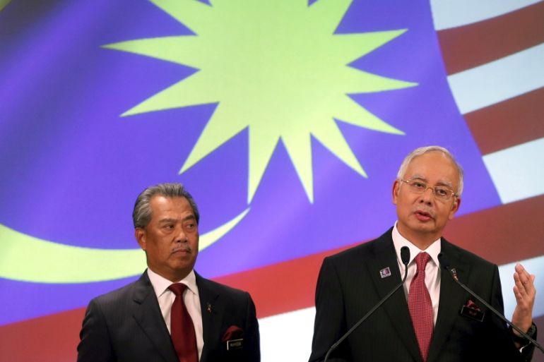 File photo of Malaysia''s PM Najib speaks as his deputy Muhyiddin listens during announcement of the new cabinet ministers lineup at his office in Putrajaya