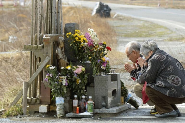 People pray for victims of the March 11, 2011 earthquake and tsunami near TEPCO''s tsunami-crippled Fukushima Daiichi nuclear power plant at Namie town