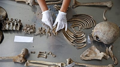 Forensic anthropologist works to identify the remains of a victim of the Srebrenica genocide [REUTERS]
