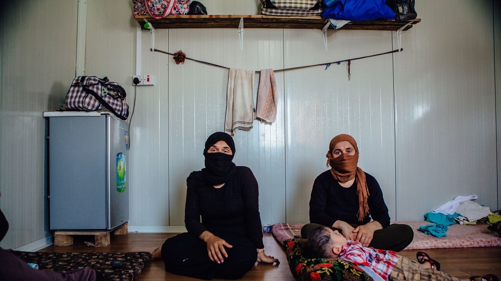 These women were enslaved by ISIL before escaping captivity and out of fear for their family's safety still living under ISIL, they cover their faces when speaking to media [Andrea DiCenzo/Al Jazeera] 