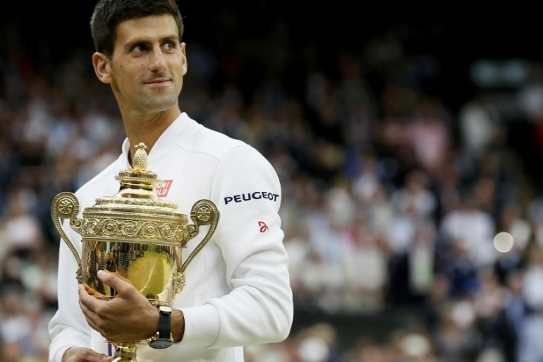 Novak Djokovic holds the trophy after winning his Men''s Singles Final match at the Wimbledon Tennis Championships in London