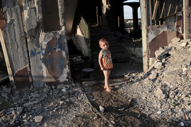 A child plays next to his family''s destroyed house damaged during the 2014 Israel-Gaza conflict, in Beit Hanun, northern Gaza Strip [EPA]