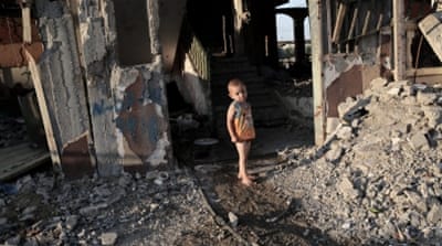 A child plays next to his family's destroyed house in Gaza [Getty]