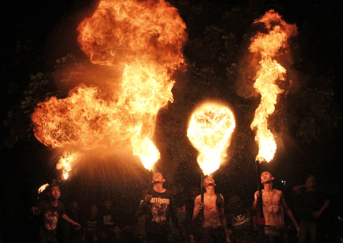 fire eaters perform during a parade to celebrate Eid al-Fitr holiday that marks the end of the holy fasting month of Ramadan in Yogyakarta, Indonesia.