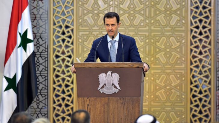 Syrian President Bashar Assad peaks at an event in Damascus