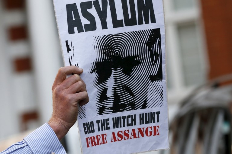 A supporter of Wikileaks founder Julian Assange holds a placard during a gathering outside the Ecuador embassy in London