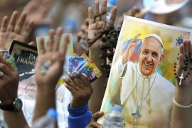 Pilgrims hold up their hands to be blessed by Pope Francis