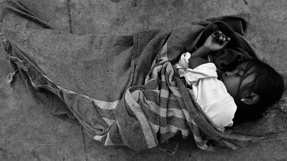 Sleeping on a street corner early in the evening, this young girl was so exhausted after scrounging for rubbish all day that she was totally oblivious to the cacophony of sound from passing traffic and people. Thousands of children displaced from Myanmar are exploited and oppressed by unscrupulous businessmen, corrupt officials and human traffickers [Jack Picone]
