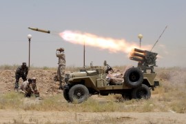 Members of Iraq''s Shi''ite paramilitaries launch a rocket towards Islamic State militants in the outskirts of the city of Falluja, in the province of Anbar