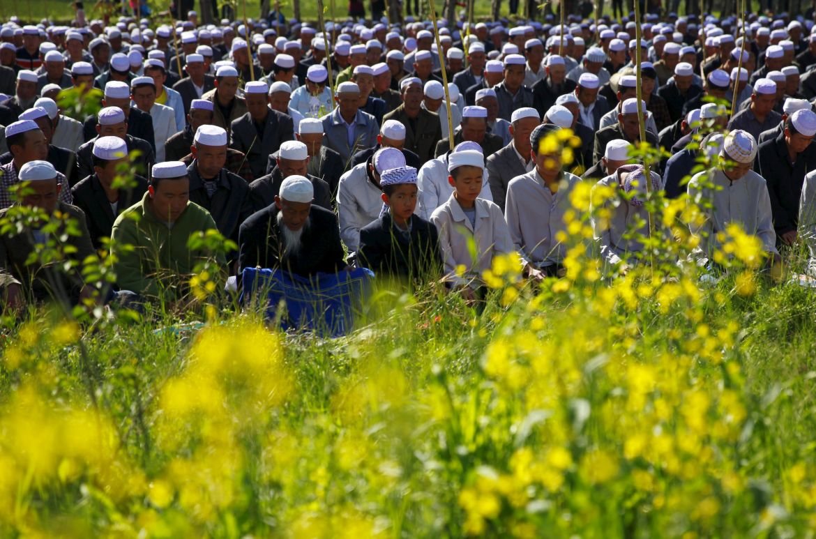 prayer session next to crop fields near a mosque during Eid al-Fitr, marking the end of the holy month of Ramadan, in Datong county, Qinghai province, China