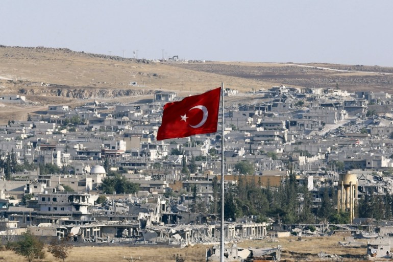 A Turkish flag, with the Syrian town of Kobani in the background, flies in the Turkish border town of Suruc [REUTERS]