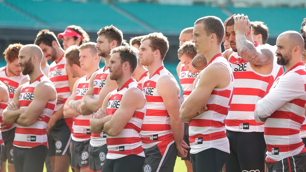Sydney Swans players stand in solidarity for Adam Goodes before a Sydney Swans AFL training session on Thursday [Getty Images]