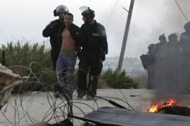 Israeli police detain a Jewish settler protesting the slated demolition of structures near Ramallah