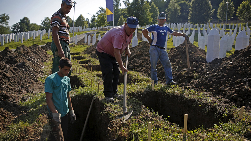 Workers dig graves at a memorial centre for Srebrenica Massacre victims in Potocari. Nearly 136 identified victims will be buried at a memorial cemetery during the ceremony, their bodies found in some 60 mass graves around the town [Dado Ruvic/Reuters]