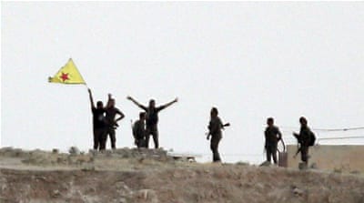 Kurdish YPG fighters wave their party's flag [AP]