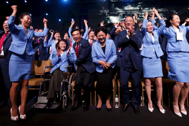 Members of the Beijing delegation celebrate after Beijing was awarded the 2022 Winter Olympic Games, defeating Almaty in the final round of voting, during the 128th IOC session in Kuala Lumpur