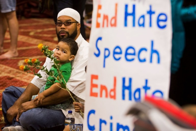 Attendees listen as speakers from different faiths speak at an interfaith rally titled "Love is Stronger than Hate" at the Islamic Community Center in Phoenix, USA