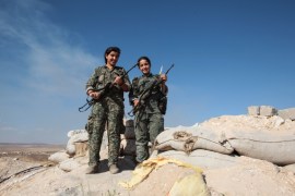 YPG''s women fighters pose as they stand in a check point with their AK-47 at the outskirts of the destroyed Syrian town of Kobane [Getty]