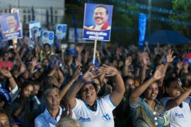 Supporters of Sri Lanka''s former president and parliamentary candidate Mahinda Rajapaksa display placards of him and applaud during a political rally to promote c