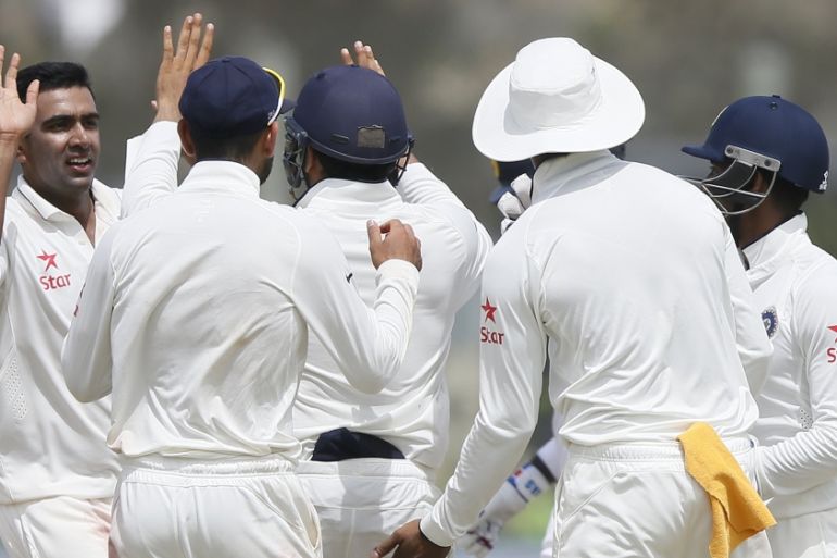India''s Ashwin celebrates with his teammates after taking the wicket of Sri Lanka''s Prasad during the first day of their first test cricket match in Galle