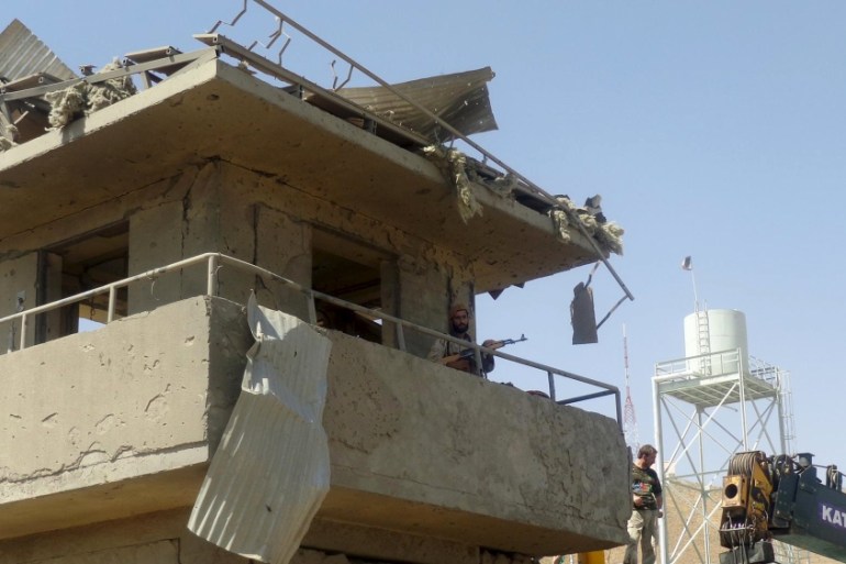 Afghan security force keeps watch at a security tower after a suicide attack in Logar