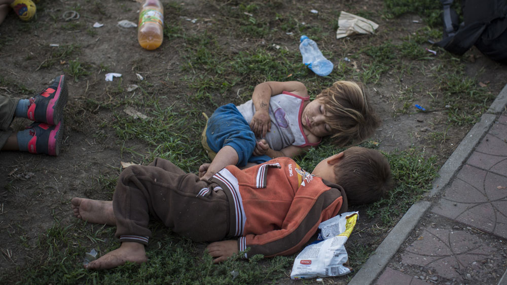 Syrian refugees, including many women with small children, sleep in a park in Belgrade [AP]