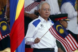 Malaysia''s Prime Minister Najib Razak waves a Malaysian national flag during National Day celebrations in Kuala Lumpur [REUTERS]