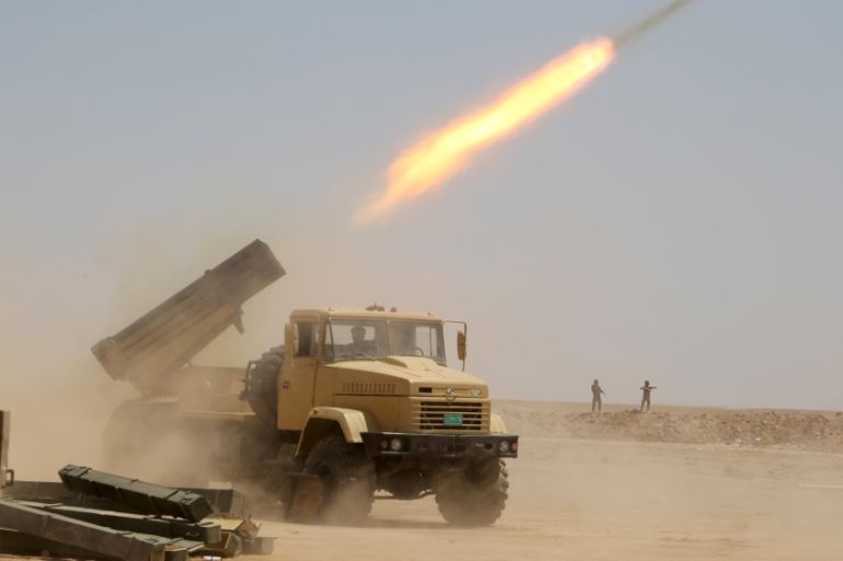 Iraqi security forces launch a rocket towards Islamic State militants on the outskirts of Anbar province