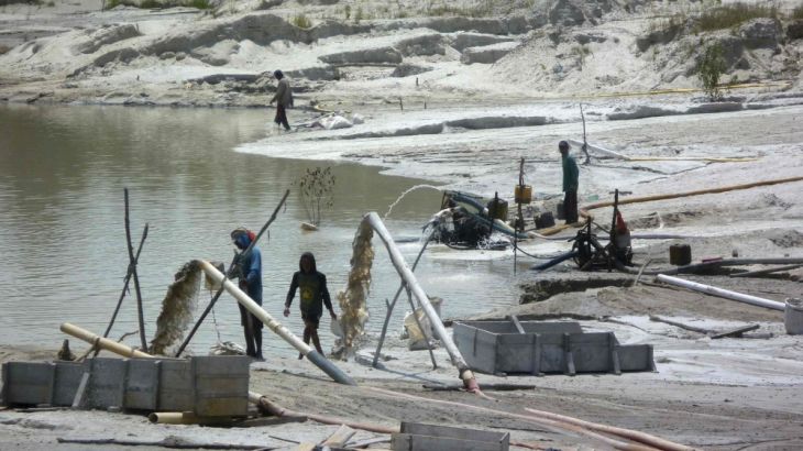 A group of illegal tin miners process tin ore on Bangka island