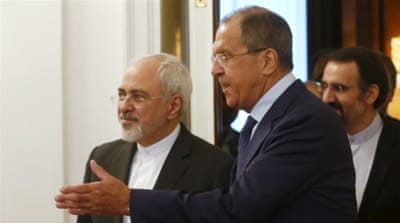Russian Foreign Minister Sergey Lavrov shows the way to his Iranian counterpart Mohammad Javad Zarif as they enter a hall during their meeting in Moscow [REUTERS]