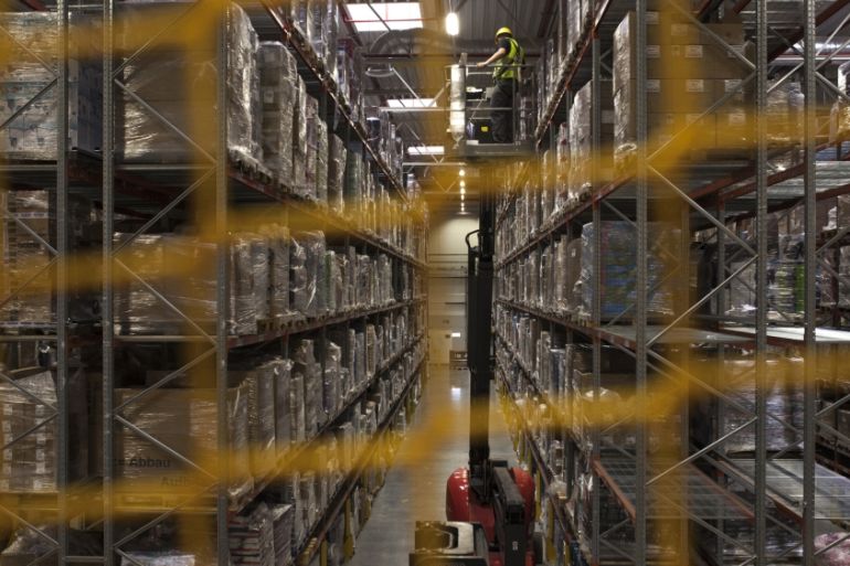 An employee is lifted by a mobile elevated work platform in the warehouse at the Amazon.com Inc. fulfillment center in Poznan, Poland [Getty]