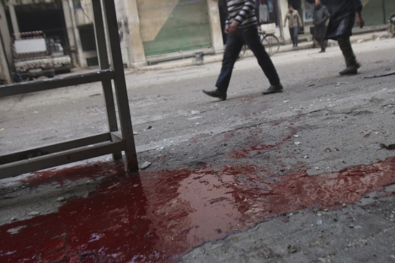 People walk past blood on the ground after what activists said was shelling by forces of Syria''s President Assad in Arbeen, in the eastern Damascus suburb of Ghouta