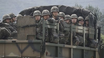 South Korean army soldiers ride on their truck in Yeoncheon, south of the demilitarised zone [AP]
