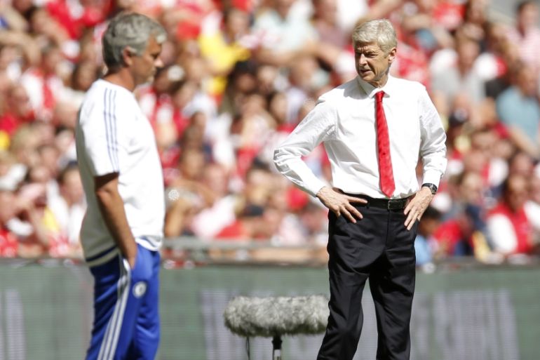 Arsenal manager Arsene Wenger and Chelsea manager Jose Mourinho (L)
