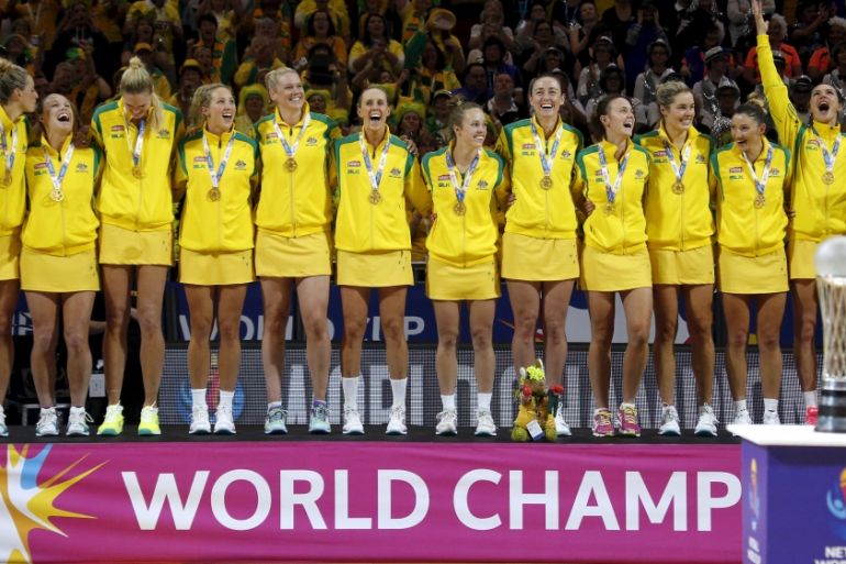 Members of the Australian team stand on the podium wearing their medals after winning their Netball World Cup final game against New Zealand in Sydney