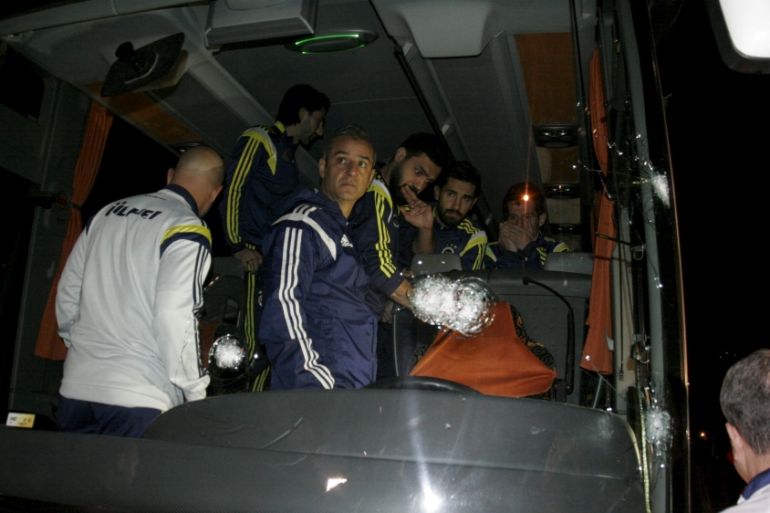 Fenerbahce''s players Emre, Alper, Bekir and Coach Ismail Kartal are seen in team bus which was shot while it has been driven through to Trabzon Airport