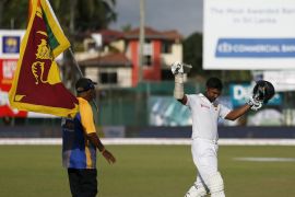 Sri Lanka''s Sangakkara waves his bat at fans as he walks off the field after his dismissal during the fourth day of their second test cricket match against India in Colombo