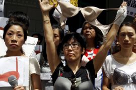 Protesters wear bras over their shirts during a demonstration in support of Hong Kong female protester Ng Lai-ying, outside the police headquarters in Hong Kong