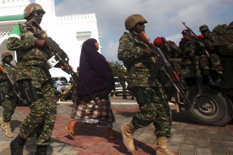 Soldiers serving in AMISOM patrol outside a Mosque